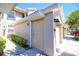 Side exterior view of a townhome showing the front door, exterior lights, and well-kept landscaping at 9435 Myrtle Creek Ln # 304, Orlando, FL 32832