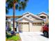 Inviting townhome featuring a two-car garage, lush landscaping, and a well-maintained facade, perfect for comfortable living at 9435 Myrtle Creek Ln # 304, Orlando, FL 32832