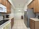 Bright and functional kitchen featuring modern appliances, ample counter space, and convenient access to the dining area at 9435 Myrtle Creek Ln # 304, Orlando, FL 32832