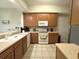 Functional kitchen featuring wood cabinetry, modern appliances, and ample counter space, ideal for cooking and meal preparation at 9435 Myrtle Creek Ln # 304, Orlando, FL 32832