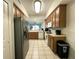Well-lit kitchen with stainless steel refrigerator and modern appliances, offering a convenient and efficient cooking area at 9435 Myrtle Creek Ln # 304, Orlando, FL 32832