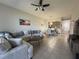 A view of a living room leading to the dining area and featuring neutral tones and tile flooring at 9435 Myrtle Creek Ln # 304, Orlando, FL 32832
