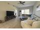 Bright living room featuring tile flooring, a ceiling fan, and comfortable seating with a view to the outside at 9435 Myrtle Creek Ln # 304, Orlando, FL 32832