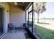 Screened patio offers outdoor seating and a view of the lush landscaping and pond at 9435 Myrtle Creek Ln # 304, Orlando, FL 32832