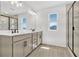 Modern bathroom features a dual vanity and sleek walk-in shower at 1003 Sugarwood St, Davenport, FL 33837