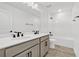 Clean bathroom featuring a dual vanity, large mirror, and a tub-shower combination at 1003 Sugarwood St, Davenport, FL 33837