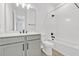 Bright bathroom features a vanity and well-lit tub-shower combination at 1003 Sugarwood St, Davenport, FL 33837