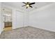 Neutral bedroom boasts plush carpet and an ensuite bathroom and closet at 1003 Sugarwood St, Davenport, FL 33837
