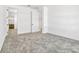 Neutral bedroom boasts plush carpet and a view into the ensuite bathroom at 1003 Sugarwood St, Davenport, FL 33837