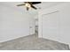 Bright bedroom features plush carpet, ceiling fan, closet, and an open doorway at 1003 Sugarwood St, Davenport, FL 33837
