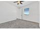 Bright bedroom features plush carpet and a sunny view from its large window at 1003 Sugarwood St, Davenport, FL 33837