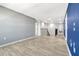Hallway with wood-look floors, access to the staircase, and natural lighting at 1003 Sugarwood St, Davenport, FL 33837