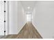 Long hallway with wood-look flooring and access to other rooms at 1003 Sugarwood St, Davenport, FL 33837