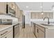 Modern kitchen featuring stainless steel appliances, light countertops, and wood laminate flooring at 1003 Sugarwood St, Davenport, FL 33837