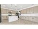Spacious kitchen with a large island, ample cabinets, and stainless steel appliances at 1003 Sugarwood St, Davenport, FL 33837