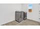 This laundry room has wood-look tile floor and is equipped with a modern washer and dryer set at 1003 Sugarwood St, Davenport, FL 33837
