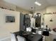 Open dining space with pendant lighting, gray cabinets, and view into the kitchen at 1019 Lake Berkley Dr, Kissimmee, FL 34746