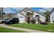 Beautifully landscaped front yard adds to the curb appeal of this lovely home at 1019 Lake Berkley Dr, Kissimmee, FL 34746