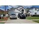 Charming single-Gathering home with a well-maintained lawn and a two-car garage at 1019 Lake Berkley Dr, Kissimmee, FL 34746
