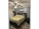 Spacious main bedroom boasts a comfortable bed, ceiling fan and wall décor at 1019 Lake Berkley Dr, Kissimmee, FL 34746