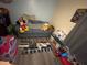 This playroom features a blue couch, a blue rug, a toy kitchen, and several cute toys at 1019 Lake Berkley Dr, Kissimmee, FL 34746