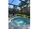 Relaxing screened-in pool area with patio chairs and lush backyard views at 1019 Lake Berkley Dr, Kissimmee, FL 34746