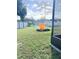 Backyard has fire pit, shed, and a white picket fence at 1102 Peregrine St, Groveland, FL 34736
