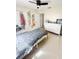 A sunlit bedroom with tile floors, closet, and a white dresser at 1102 Peregrine St, Groveland, FL 34736