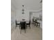 A dining area complemented with tile flooring, a modern light fixture, and bar stool seating at 1102 Peregrine St, Groveland, FL 34736