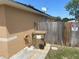 Exterior side view of home featuring a fence, trash container, and a satellite dish at 1102 Peregrine St, Groveland, FL 34736
