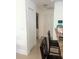 Bright hallway with tile flooring, storage closet and neutral paint, offering versatile access at 1102 Peregrine St, Groveland, FL 34736