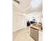Open kitchen featuring tile floors, stainless steel dishwasher, and granite countertops at 1102 Peregrine St, Groveland, FL 34736