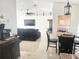 An open-concept living room area, with dining and kitchen area adjacent at 1102 Peregrine St, Groveland, FL 34736
