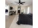 Spacious main bedroom with a ceiling fan, ensuite, and a bright window at 1102 Peregrine St, Groveland, FL 34736
