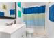 Bright bathroom with a clean white vanity, colorful shower curtain, and artistic decor at 1190 Sandestin Way, Orlando, FL 32824