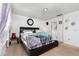 Well-lit bedroom featuring a plush bed, ample natural light, and a view of the backyard at 1190 Sandestin Way, Orlando, FL 32824