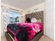 Comfortable bedroom featuring a plush headboard, soft lighting, and a pleasant view from the window at 1190 Sandestin Way, Orlando, FL 32824