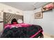 Bedroom with a tufted headboard and wall decorations, creating a cozy and inviting atmosphere at 1190 Sandestin Way, Orlando, FL 32824