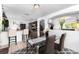 Charming dining area with bar access to the kitchen, a modern glass table and comfortable seating at 1190 Sandestin Way, Orlando, FL 32824