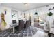 Bright dining room with contemporary decor, dining table, and view of backyard pool through sliding glass doors at 1190 Sandestin Way, Orlando, FL 32824