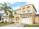 Inviting two-story home with a well-manicured lawn and a charming front porch with an attached two-car garage at 1190 Sandestin Way, Orlando, FL 32824