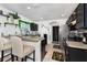 Cozy kitchen with black cabinetry, eat-in bar, stainless steel appliances, and decorative 'EAT' wall art at 1190 Sandestin Way, Orlando, FL 32824