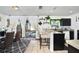 Bright kitchen area with bar seating, black cabinets, and sliding glass doors to pool at 1190 Sandestin Way, Orlando, FL 32824