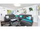 Comfortable living room with stylish gray sofa, modern decor, and a view into the outdoor backyard at 1190 Sandestin Way, Orlando, FL 32824