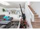 Bright living room with staircase, featuring contemporary decor, stylish furnishings and staircase to upper level at 1190 Sandestin Way, Orlando, FL 32824