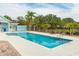A large rectangle pool is surrounded by a concrete deck, palm trees, and a picnic table at 1190 Sandestin Way, Orlando, FL 32824