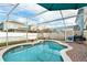 Inviting screened-in pool area with a brick patio, perfect for outdoor relaxation and entertaining at 1190 Sandestin Way, Orlando, FL 32824