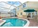 Beautiful pool area with a screened enclosure, brick patio, and outdoor seating, ideal for leisure at 1190 Sandestin Way, Orlando, FL 32824