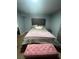 Comfortable bedroom featuring stylish upholstered headboard and soft, inviting bedding at 130 Avenue H Se, Winter Haven, FL 33880