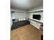This bedroom features neutral carpet, wall shelves, and built-in desk area at 130 Avenue H Se, Winter Haven, FL 33880